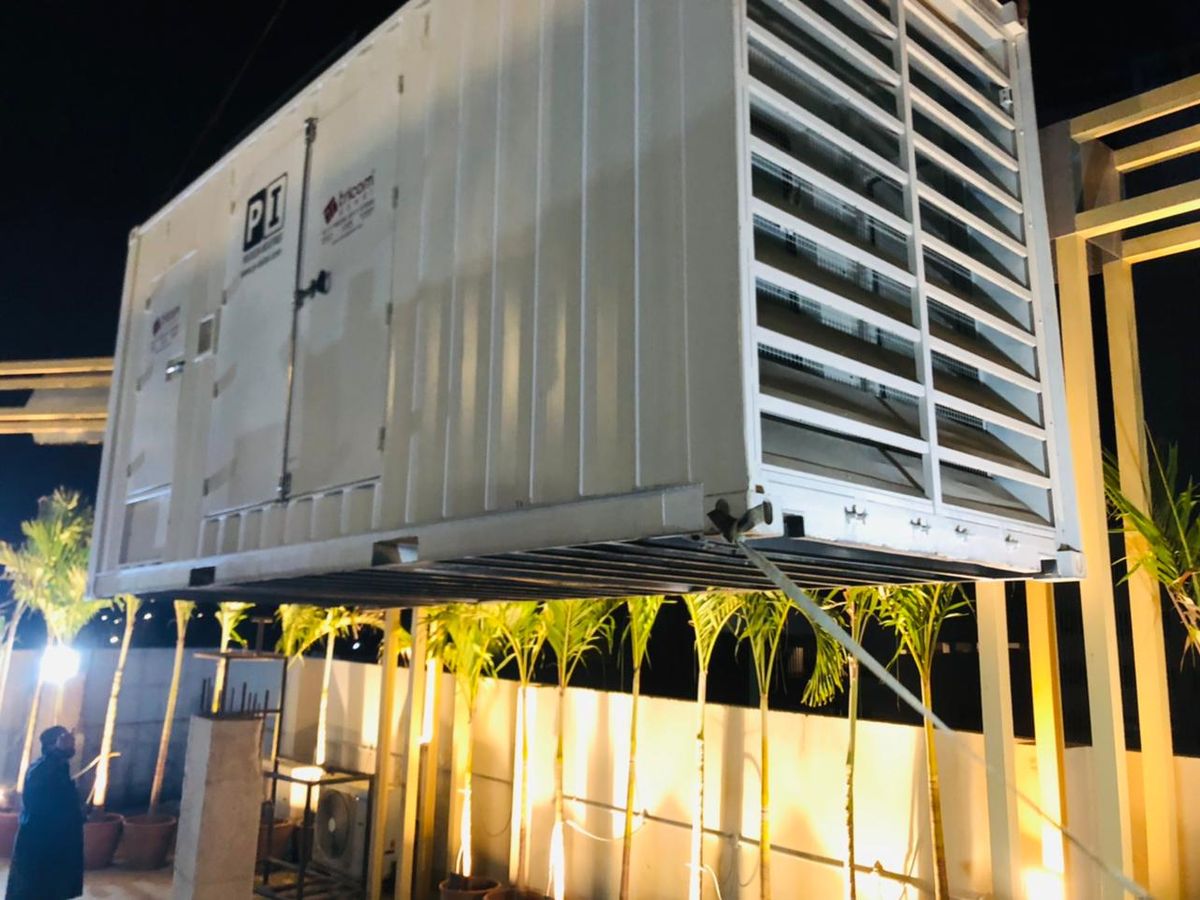 Night lift of a containerized set onto a rooftop
